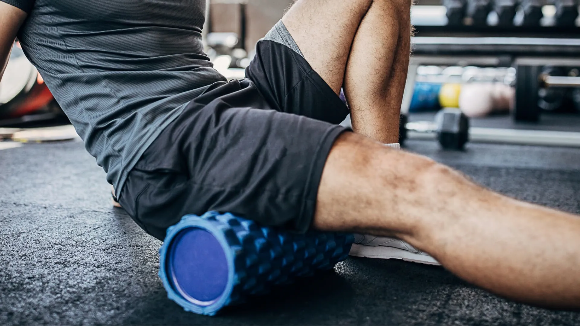 A person using a form roller on their leg